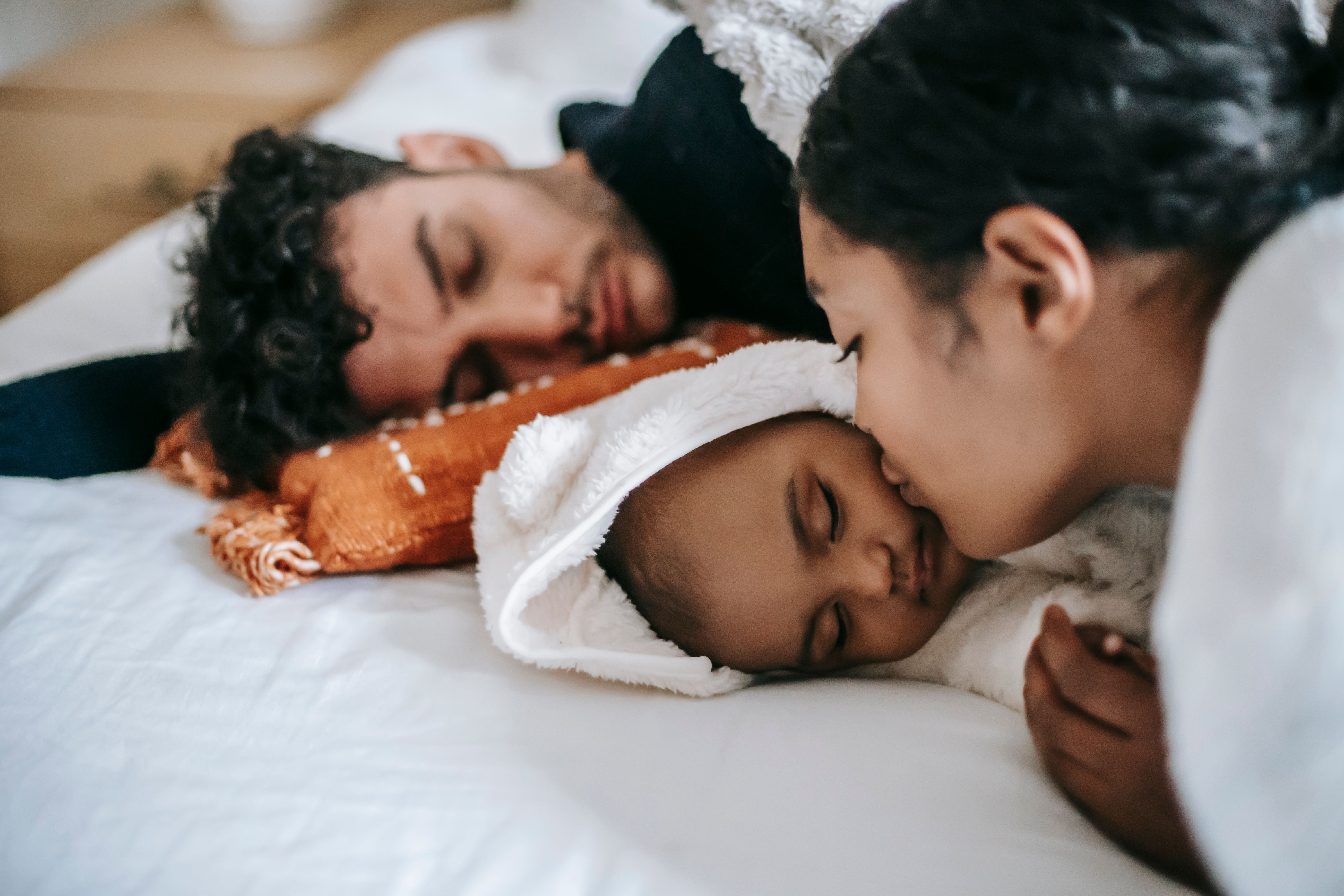Parents resting with a newborn during a quiet family session